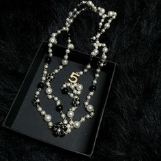 Classic chic, this beautiful designer double strand No. 5 camelia flower necklace is stunning with suits or dresses. Bride Pearl Necklace, Chanel 5, Bridal Jewelry Pearl Sets, Bridal Pearl Necklace, Black Pearl Necklace, Wedding Accessories Jewelry, Free Earrings, Necklace Black, Bridal Pearls