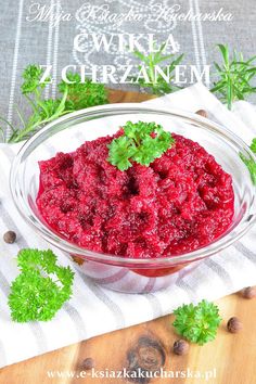 a bowl filled with cranberry sauce on top of a table