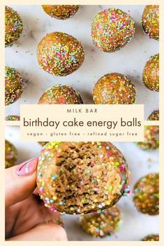 a person holding a cake energy ball in front of some sprinkled balls