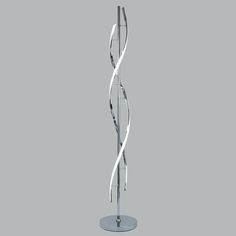 a tall metal sculpture on top of a table