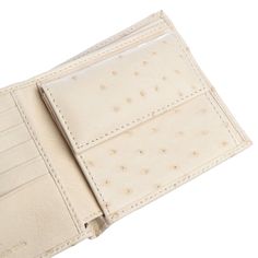 Ivory White Real Ostrich Skin Leather Wallet New!Rare    Made of top-quality genuine ostrich leather ;  Size closed: 11 cm x 10.3 cm (4 1/3” x 4”);  Size open: 11 cm x 20.6 cm (4 1/3” x 8”);  Luxurious ivory white finish;  Bi-fold design;  Internal layout: 1 coin slot, 7 card slots, 2 bill compartments;  Hand-made product.   Our Ivory White Genuine Ostrich Skin Leather Wallet prove that luxury can be affordable. We ask a fair price for these hand-made bi-folds that display unique ostrich leather Cream Leather Bifold Wallet, Luxury Elegant White Wallets, Luxury Cream Leather Wallet, Luxury Leather Wallet With Silver-tone Hardware, Coin Slot, Ostrich Leather, Leather Wallets, Ivory White, Card Slots