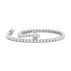 Designed with a clean and pared-down line of diamonds, this modern tennis bracelet will fit a minimalist's jewelry collection. The bracelet features a strand of polished precious metal "nuggets" topped with a round diamond. Compared to the usual prong baskets, the "nuggets" that secure each diamond in this bracelet feature a more solid base and a U-shaped recess where the precious gem can safely sit. Modern White Gold Tennis Bracelet For Anniversary, Modern White Gold Diamond Bracelet With Vvs Clarity, Modern Round Diamond Tennis Bracelet, Classic White Gold Tennis Bracelet For Everyday Luxury, Minimalist White Gold Diamond Tennis Bracelet, Minimalist White Gold Tennis Bracelet For Formal Occasions, Modern White Gold Tennis Bracelet, Modern Diamond White Tennis Bracelet With Jubilee Style, Modern White Gold Tennis Bracelet With Jubilee Design