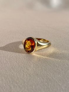 10k yellow gold signet ring by 23carat featuring a beautiful faceted citrine in a bezel setting. Excellent condition Size: 6.75 resizable* Weight: 5.7 grams Band: 11.0 mm (front), 3.0 mm (back) Citrine: 9.0 mm x 8.0 mm oval cut Hallmarks: 10k, water barrel and heart for 23carat Handmade to order, please allow for approximately 1 to 3 weeks before shipping For more details or customization options, emails us at info@shop23carat.com Luxury Citrine Jewelry With Bezel Setting, Fine Jewelry Citrine Bezel Setting, Elegant Citrine Gemstone Signet Ring, Luxury Gold Citrine Signet Ring, Oval Cabochon Citrine Rings, Water Barrel, Gold Signet Ring, Signet Ring, Bezel Setting