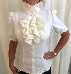 Vintage short sleeved high neck white ruffle blouse.  Sz:  XS 31" Bust 13.5" Shoulder 24". Length Excellent Condition White Ruffled Blouse For Office, Fitted Ruffle Blouse For Office, Fitted White Shirt With Ruffled Collar, White Fitted Shirt With Ruffled Collar, Fitted White Shirt With Ruffles, Formal White Ruffled Shirt, White Ruffled Shirt For Formal Occasions, White Ruffle Sleeve Office Blouse, White Ruffled Tops For Office