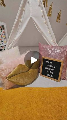 a bed with pink and gold decorations on the headboard, pillows, and a sign that says happy golden birthday