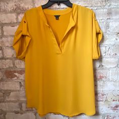 Ann Taylor Yellow/Gold Silky Shirt. Never Worn And Fits Big. Size Small. Yellow Short Sleeve Tops For Work, Gold Casual Shirt For Spring, Casual Gold Shirt For Spring, Casual Gold Blouse For Day Out, Trendy Yellow Shirt For A Day Out, Casual Yellow Shirt For Work, Gold Summer Top For Workwear, Yellow Short Sleeve Blouse For Day Out, Yellow Short Sleeve Shirt For Day Out