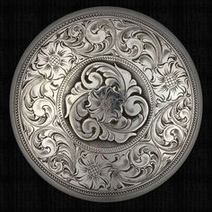 an intricately designed silver plate with flowers and leaves on it's side, against a black background