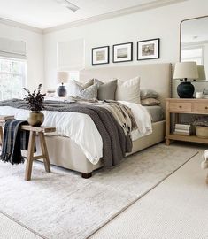 a bedroom with a large bed and white carpet