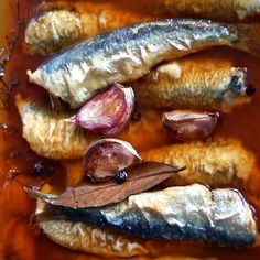 an assortment of fish and garlic on a plate