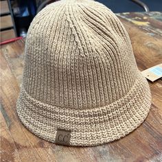 Light Brown C.C Bucket Hat Knit Texture Adjustable Strap For The Perfect Fit Authentic C.C Brand And Quality 100% Cuddly Warm Acrylic Beige Soft Knit Hat One Size, Beige Soft Knit Cap, Beige Soft Knit Hat, Cozy Beige Knit Crochet Hat, Cozy Beige Crochet Knit Hat, Brown Casual Cloche Hat One Size, Casual Wide Brim Knitted Hat, Casual Knitted Cloche Hat For Fall, Beige Soft Knit Crochet Hat For Fall