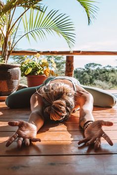 a woman is doing yoga on the deck