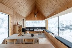 a living room filled with furniture and wooden walls