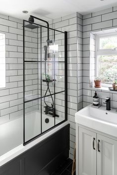 a black and white bathroom with a large shower