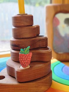 a wooden tower with a strawberry on top