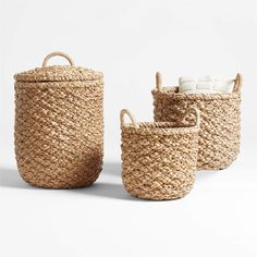 three woven baskets with handles and handles, one in natural jute material the other in white cotton