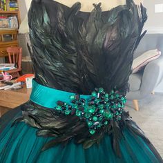 a dress with feathers and beads on it