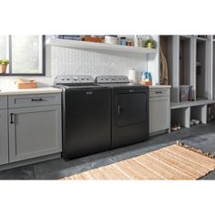 a black washer and dryer in a kitchen