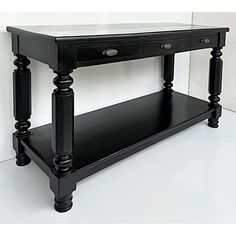 a black console table with two drawers and one drawer on the bottom, in front of a white wall