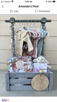 a wooden crate filled with lots of baby clothes and stuffed animals next to a sign that says amanda's post