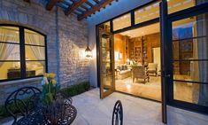 an outdoor living room and dining area at night