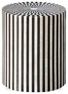 a black and white striped table sitting on top of a floor