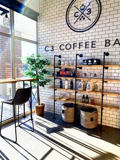 a coffee shop with brick walls and shelves