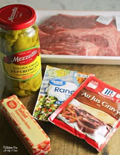 meat, cheese and other ingredients are sitting on a counter top next to a jar of mustard