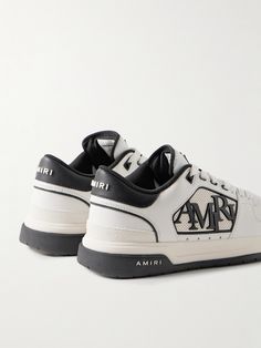 AMIRI upgrades traditional court sneakers with its signature iconography in this 'Classic Low' pair. Detailed with a staggered logo and signature star perforations, they have leather uppers, suede trims and stacked, two-tone rubber soles. Wear them with the label's jeans or track pants. Classic Custom Sneakers With Logo For Streetwear, Classic Custom Sneakers With Embossed Logo For Sports, Luxury Logo Sneakers For Sports, Classic High-top Custom Sneakers With Embossed Logo, Sporty Custom Leather Sneakers With Embroidered Logo, Luxury Sneakers With Embossed Logo For Streetwear, Luxury Logo Print Sneakers For Sports, Designer Custom Low-top Sneakers With Logo, Custom Leather Sneakers With Logo For Streetwear