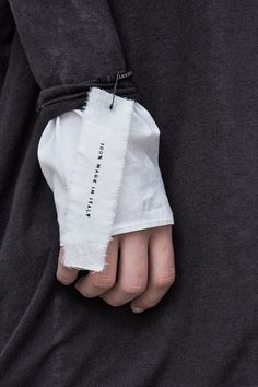 a person's hand with a piece of cloth wrapped around their thumb and the other part of his arm