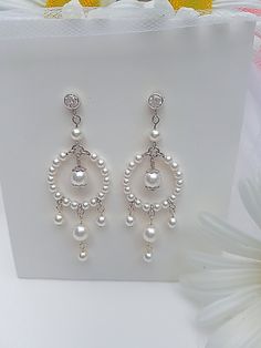 Elegant Formal Chandelier Earrings With Dangling Beads, Wedding Bridal Earrings With Dangling Beads, Wedding Bridal Dangle Earrings With Beads, Dangling Beads Bridal Earrings For Wedding, Formal White Pierced Chandelier Earrings, White Pierced Chandelier Earrings For Formal Occasions, Elegant White Clip-on Chandelier Earrings, Elegant White Crystal Dangle Earrings, White Elegant Dangle Crystal Earrings