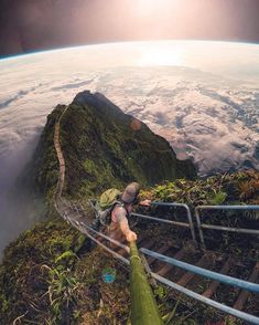 a person climbing up some stairs in the sky