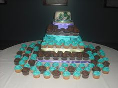 a triple tiered cake with cupcakes on the bottom and blue frosting