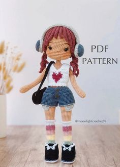 a crocheted doll with headphones and a handbag