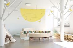 the interior of a children's playroom with bookshelves and toys in it