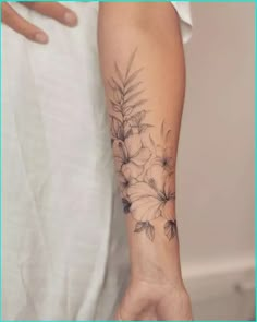 a person with a flower tattoo on their arm