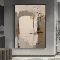 an abstract painting hangs on the wall in a modern living room