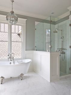 a white bath tub sitting next to a walk in shower