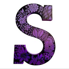 the letter s is decorated with purple flowers and skulls on it's sides,