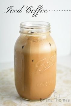 an iced coffee in a mason jar with the words iced coffee written on it's side