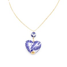 The subtle chain makes the necklace seem delicate which is a go to when looking for something that can look both elegant and classy at the same time! The Talavera heart as well as the Talavera bead has been handmade and takes lots of time and patience. Our Mexican artisans dedicate valuable time of their lives to be able to make this gorgeous product just for you! Handmade Jewelry Made with Clay, Stainless Steel, and 14k gold plated.  Colors used: Cobalt blue, white, and gold. Measurements: Leng Elegant Blue Necklaces For Valentine's Day, Elegant Blue Heart Necklace, Elegant Blue Jewelry With Heart Beads, Blue Clavicle Chain Necklace As A Gift For Her, Blue Flower Pendant Necklace Gift For Her, Blue Flower Pendant Necklace For Her, Blue Flower Pendant Necklace As A Gift For Her, Blue Heart Pendant Necklace As Gift For Her, Blue Heart Shaped Clavicle Chain Necklace