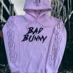 Brand New (Nwot) Bad Bunny Hoodie (Light Pink) With Bad Bunny On The Front, Bunny Ears On The Hood And Bunnies Down The Sleeves (Black). Casual Pink Winter Sweatshirt, Urban Pink Tops For Spring, Urban Style Pink Tops For Spring, Pink Long Sleeve Hoodie For Streetwear, Pink Winter Hoodie, Pink Hooded Hoodie With Graphic Print, Pink Graphic Print Hooded Hoodie, Cute Hooded Sweatshirt For Spring, Pink Hooded Sweatshirt For Streetwear