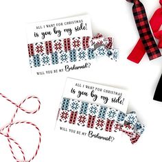 two christmas gift tags with red, white and blue ribbon tied to them on top of each other