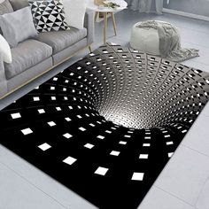 a living room area with couches and rugs on the floor, all in black and white