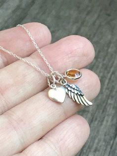 925 Sterling Silver Tiny Memorial/Guardian Angel Wing Birthstone Necklace  1 - 16mm Tiny .925 Sterling Silver Angel Wing 1-  6mm, Silver Plated Swarovski Birthstone Dangle Charm 1- 12mm heart charm .925 Sterling Silver Cable or Box Chain, you choose style & length  Comes beautifully packaged - ready to give as a gift or keep for yourself!OUR SHOP: FOREVER MEMORY DESIGNS : http://www.etsy.com/shop/forevermemorydesigns Tiny Sterling Silver Charm Necklaces For Anniversary, Dainty Sterling Silver Charm Necklaces For Keepsake, Tiny Sterling Silver Charm Necklace For Anniversary, Sterling Silver Charms Jewelry For Memorial, Memorial Sterling Silver Round Pendant Charm Necklace, Spiritual Sterling Silver Charm Necklaces For Keepsake, Sterling Silver Necklace For Remembrance, Sterling Silver Charm Necklace For Memorial, Spiritual Sterling Silver Charm Necklace For Keepsake