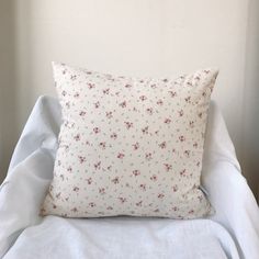 a white pillow sitting on top of a bed