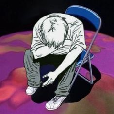 a man sitting on top of a blue chair next to a pink and purple planet