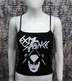 This is a black Exit-Stance crop tank top with spaghetti straps. This has a Exit-Stance image screen printed on the front. 57% cotton/ 38% polyester/ 5% SpandexThese are handmade screenprinted and slightly vary from the photo. Please feel free to email me any questions. Thanks for looking.Due to an influx of incorrect addresses if a package is returned,  you must pay the shipping cost to resend the item to you.I do not do exchanges and I do not take returns unless the item is damaged. I thorough Stretch Punk Crop Top For Streetwear, Y2k Black Tank Top For Streetwear, Fitted Grunge Tank Top With Graphic Print, Punk Graphic Print Crop Top For Spring, Spring Punk Crop Top With Graphic Print, Spring Punk Style Graphic Print Crop Top, Stretch Grunge Graphic Print Crop Top, Fitted Cropped Tank Top For Streetwear, Edgy Cropped Tank Top For Summer