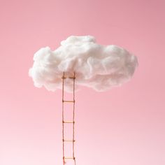 a cloud shaped like a ladder on top of a pink background