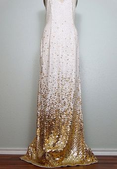 "This is an absolutely breathtaking gown. It's fully embellished with bright white and gold sequins and accented with tiny gold beading between each and every sequin. The straps are also embellished with gold glass beading. It's in excellent condition! Measurements: Bust - 32-36\" Waist - 26-30\" Hips - 36-40\" Total Length - 61\" This dress comes from a pet-free and smoke-free home. If you would like more info or have any questions, please don't hesitate to ask!" Gold Sparkling Gown For Prom Season, Gold Sparkling Sequin Dress For Wedding, Glamorous Gold Hand-embellished Gown, Glamorous Gold Sequin Fabric For Prom Season, Gold Sequined Evening Gown, Gold Embellished Sequin Fabric For Evening Dress, White Embellished Sequin Dress For Prom, Gold Sequin Gown For Evening, Gold Sequined Gown For Prom