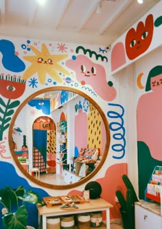 there is a mirror on the wall in front of a room with colorful walls and plants